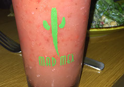 Mad Mex logo on a glass